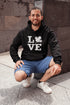 Canada LOVE hoodie with Canadian maple leaf graphic on a black unisex sweatshirt