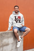 Love Canada hoodie featuring bold black lettering and red Canadian maple leaf graphic on a unisex sweatshirt