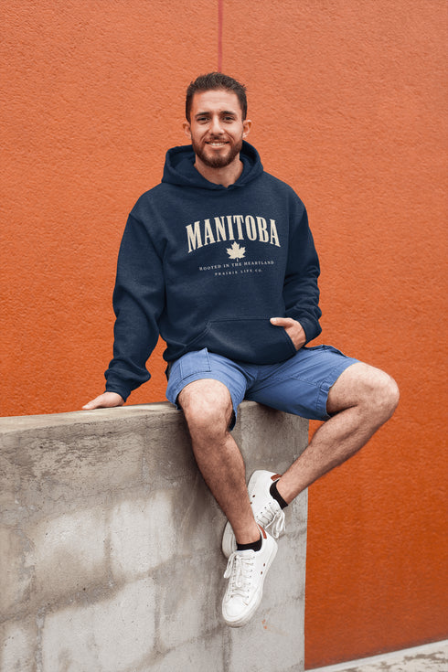 Manitoba Rooted in the Heartland hoodie with maple leaf and vintage collegiate lettering on a unisex Gildan sweatshirt