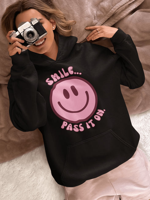 Introducing the ultimate mood booster in fabric form: the "Smile…Pass It On" Happy Face Hoodie! This isn't just any ordinary hoodie; it's a wearable ray of sunshine, guaranteed to spread joy, high-fives, and possibly even spontaneous dance-offs wherever you go.