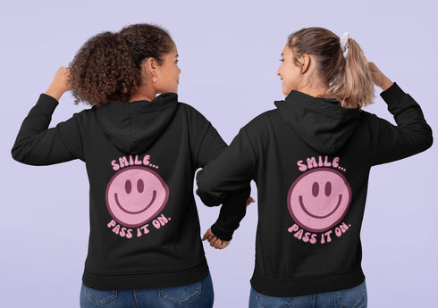 Introducing the latest must-have in your wardrobe that's guaranteed to turn frowns upside down: the Happy Face Hoodie emblazoned with the cheer-spreading command, "Smile...Pass it on." This isn't just any ordinary hoodie; it's your ticket to becoming a walking, talking (and very cozy) ambassador of joy!