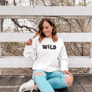 Introducing our gender-neutral sweatshirt with the bold and adventurous saying "Wild". Whether you're hitting the trails, going on an adventure, or heading out for a day of hiking, this sweater is the perfect addition to your outdoor wardrobe.