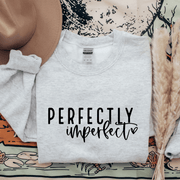 Introducing our latest addition to the collection - the gender-neutral sweatshirt with the inspiring message "Perfectly Imperfect". Made from high-quality materials, this sweatshirt is designed to be both comfortable and durable. 