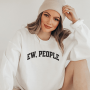 Introducing a sweatshirt that will make all the introverts and homebodies out there jump with joy! This gender-neutral sweatshirt is perfect for those who prefer to stay indoors and avoid the chaos of the outside world. With the witty slogan "Ew, People" printed on the front, you'll never have to explain your social preferences again. 