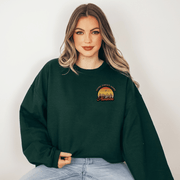 Introducing the perfect addition to your wardrobe for those chilly Canadian nights - our gender neutral Manitoba Home Sweet Home Sweatshirt! Designed with a stunning Prairie sunset on the back, complete with wheat and the phrase "Home Sweet Home Manitoba," this sweater is not only stylish but also serves as a nod to your love for the beautiful Canadian nature. 