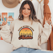 Introducing the perfect addition to your wardrobe for those chilly Canadian nights - our gender neutral Manitoba Home Sweet Home Sweatshirt! Designed with a stunning Prairie sunset, complete with wheat and the phrase "Home Sweet Home Manitoba," this sweater is not only stylish but also serves as a nod to your love for the beautiful Canadian nature. 