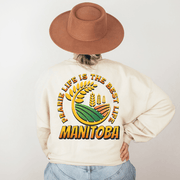 Introducing the perfect addition to your wardrobe: the Prairie Life Is The Best Life-Manitoba sweatshirt. This gender-neutral nature shirt features a stunning graphic of a farmer's field, complete with wheat stalks swaying in the breeze.