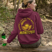 This gender neutral hoodie features a stunning graphic of a farmer's field with golden wheat and a breathtaking prairie sunset. The saying "Prairie Life Is The Best Life-Manitoba" is proudly displayed, representing the love and appreciation for the simple yet fulfilling life in this wonderful province. 