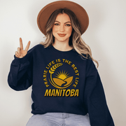 This cozy sweatshirt features a stunning graphic of a farmer's field with golden wheat and a beautiful prairie sunset. As an ode to the gorgeous Canadian province of Manitoba, this sweatshirt displays the saying "Prairie Life Is The Best Life-Manitoba." 