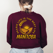 This Canada Sweater features a beautiful farmers field graphic with wheat and a prairie sunset, as well as the saying "Prairie Life Is The Best Life-Manitoba". 