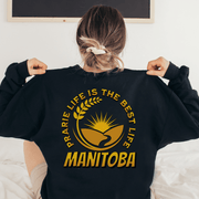 This Canada Sweater features a beautiful farmers field graphic with wheat and a prairie sunset, as well as the saying "Prairie Life Is The Best Life-Manitoba".