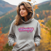 Introducing the perfect addition to your wardrobe - our trendy gender-neutral hoodie with a retro graphic design and the words "Winnipeg" in rainbow colors! 