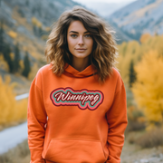 Our trendy gender-neutral hoodie features a retro graphic with the words “Winnipeg” in rainbow colors! This custom hoodie is a must-have for anyone looking to show off their Canadian pride and love for the city of Winnipeg.