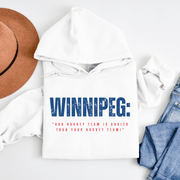 Introducing the coolest hoodie in town - our Winnipeg graphic hockey hoodie! With the hockey season in full swing, you'll want to show off your love for our team in style. Our hoodie features the slogan "Our Hockey Team is Cooler Than Your Hockey Team" in bold, eye-catching letters that are sure to make everyone around you jealous. 