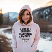 Introducing the ultimate graphic hoodie for all the hockey fans out there - the 4 Out Of 5 Dentists Recommend Hockey hoodie! This gender-neutral hoodie is perfect to wear during hockey season and will surely make you stand out from the crowd. Featuring a quirky design of a smiling mouth with a missing tooth, this hoodie is sure to bring a smile to everyone's face. 