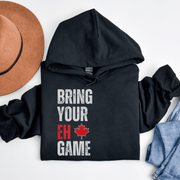 Introducing the ultimate hockey hoodie for anyone who wants to bring their EH game to the rink! Whether you're a seasoned veteran or a newbie to the sport, this funny hockey hoodie is the perfect addition to your wardrobe. Made from soft and comfortable material, this hockey hoodie is perfect for keeping you warm during those chilly games. And with the hilarious "Bring Your EH Game" slogan emblazoned across the front, you'll be sure to get a few chuckles from your teammates.
