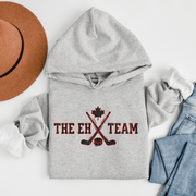 Introducing the ultimate hockey hoodie for all the true hockey fans out there - The EH Team Hoodie! This gender-neutral hoodie is the perfect addition to any hockey player's wardrobe. Whether you're skating on the ice or cheering from the stands, this hoodie will keep you warm and stylish. But let's be real, the best part of this hoodie is the hilarious pun. The EH Team? More like the A+ pun team! You'll have everyone cracking up at the rink with this funny hockey hoodie. 