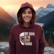 Introducing the ultimate hockey hoodie for all you puck-loving, goal-denying warriors out there! With our gender-neutral design, you'll look great whether you're body-checking your opponent or sipping hot cocoa in the stands. But the real star of the show is the goalie mask emblazoned with the words "My Goal Is To Deny Yours". It's like a personal challenge to every other player on the ice, and a declaration of your supreme goaltending skills (even if you're just a beginner). 