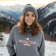 Looking for a hilarious way to show your love for Canadian hockey? Look no further than The EH Team hockey hoodie! This gender neutral hoodie is perfect for all hockey players, fans, and anyone who loves a good puck joke. Made from the comfiest material this side of the border, The EH Team hoodie will keep you warm and cozy on even the chilliest of rinks. And with its witty play on words, you'll be the envy of all your hockey buddies.
