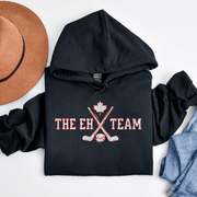 Looking for a hilarious way to show your love for Canadian hockey? Look no further than The EH Team hockey hoodie! This gender neutral hoodie is perfect for all hockey players, fans, and anyone who loves a good puck joke. Made from the comfiest material this side of the border, The EH Team hoodie will keep you warm and cozy on even the chilliest of rinks. And with its witty play on words, you'll be the envy of all your hockey buddies. 