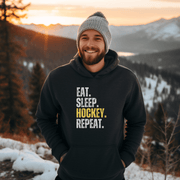 This hockey hoodie is not just any regular hoodie, it's the perfect blend of style, comfort and humor. With the catchy phrase "Eat. Sleep. Hockey. Repeat." printed on it, this hoodie is sure to grab attention and make heads turn.
