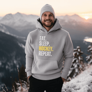 This hockey hoodie is not just any regular hoodie, it's the perfect blend of style, comfort and humor. With the catchy phrase "Eat. Sleep. Hockey. Repeat." printed on it, this hoodie is sure to grab attention and make heads turn. 