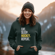 This hockey hoodie is not just any regular hoodie, it's the perfect blend of style, comfort and humor. With the catchy phrase "Eat. Sleep. Hockey. Repeat." printed on it, this hoodie is sure to grab attention and make heads turn. 