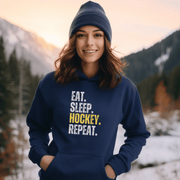 This hockey hoodie is not just any regular hoodie, it's the perfect blend of style, comfort and humor. With the catchy phrase "Eat. Sleep. Hockey. Repeat." printed on it, this hoodie is sure to grab attention and make heads turn. 