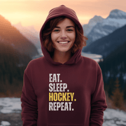 This hockey hoodie is not just any regular hoodie, it's the perfect blend of style, comfort and humor. With the catchy phrase "Eat. Sleep. Hockey. Repeat." printed on it, this hoodie is sure to grab attention and make heads turn. 
