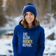 This hockey hoodie is not just any regular hoodie, it's the perfect blend of style, comfort and humor. With the catchy phrase "Eat. Sleep. Hockey. Repeat." printed on it, this hoodie is sure to grab attention and make heads turn.