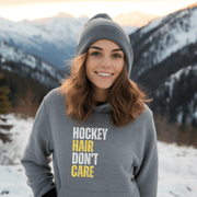 Introducing the perfect accessory for any hockey player or fan - our hilarious gender neutral hockey hoodie! This hoodie is not only stylish but also practical, with a cozy design that is perfect for keeping you warm during those chilly hockey games. Featuring the witty slogan "Hockey Hair Don’t Care", this funny hockey hoodie is the perfect way to show off your love for the game and your luscious locks