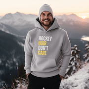 Introducing the perfect accessory for any hockey player or fan - our hilarious gender neutral hockey hoodie! This hoodie is not only stylish but also practical, with a cozy design that is perfect for keeping you warm during those chilly hockey games. Featuring the witty slogan "Hockey Hair Don’t Care", this funny hockey hoodie is the perfect way to show off your love for the game and your luscious locks