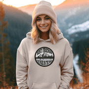 This gender-neutral hoodie is perfect for anyone who loves hockey and is proud to show it. With a graphic featuring people playing pond hockey with a stunning mountain background, this hoodie is sure to turn heads and start conversations. 