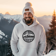 This gender-neutral hoodie is perfect for anyone who loves hockey and is proud to show it. With a graphic featuring people playing pond hockey with a stunning mountain background, this hoodie is sure to turn heads and start conversations. 