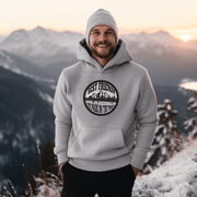 This gender-neutral hoodie is perfect for anyone who loves hockey and is proud to show it. With a graphic featuring people playing pond hockey with a stunning mountain background, this hoodie is sure to turn heads and start conversations. 