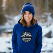 This gender-neutral hoodie is perfect for anyone who loves hockey and is proud to show it. With a graphic featuring people playing pond hockey with a stunning mountain background, this hoodie is sure to turn heads and start conversations. 