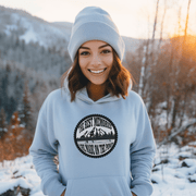 This gender-neutral hoodie is designed especially for those who love the game and want to show off their passion for it. With a graphic featuring people playing pond hockey with a beautiful mountain background, this hoodie is perfect for those who enjoy outdoor hockey in the Canadian winter. 