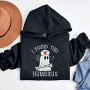 Looking for a spooky and stylish way to scare up some laughs this Halloween? Look no further than our bone-tickling Halloween Sweatshirt, featuring a ghostly nurse with a killer sense of humor! With the hilarious slogan "I Found This Humerus" emblazoned across the chest, this sweatshirt is guaranteed to have all your friends in stitches. And with its cozy fabric and comfy fit, you'll be the envy of all the ghouls and ghosts at the Halloween party. 