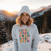 Introducing our new gender-neutral hoodie, perfect for embracing fall vibes. With its colorful fall palette and the saying "Flannels, Hayrides, Pumpkins, Bonfires, Sweaters" emblazoned on the front, this hoodie is the perfect addition to any fall wardrobe.