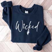 Our gender-neutral sweatshirt is the perfect addition to your spooky wardrobe, and it's guaranteed to make heads turn. With the wickedly cool design of a witch's broom and the word "Wicked" emblazoned across the front, this sweatshirt will have you feeling like the baddest witch in town. 