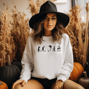  This gender-neutral sweatshirt is perfect for the upcoming Spooky Season, featuring adorable ghosts holding black cats. It's the perfect way to show off your love for Halloween, ghosts, and cats all at once.