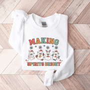 Introducing the festive sweatshirt that will make you the life of any holiday party! This gender-neutral sweatshirt features the cutest ghosts wearing Santa hats with the saying "Making Spirits Bright".