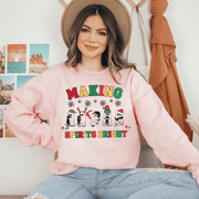 Get ready to spread some serious holiday cheer with our cute Christmas shirt featuring adorable ghosts wearing Santa hats and holding black cats with the saying "Making Spirits Bright".