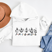 Introducing the ultimate hoodie for all your holiday lounging needs - our gender-neutral hoodie featuring adorable Christmas gnomes and the iconic word "FRIENDS" from the TV show Friends! 