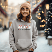 Introducing the ultimate holiday season staple: the gender-neutral hoodie featuring adorable Christmas Cartoon Cats and the iconic "FRIENDS" logo from the beloved TV show! 