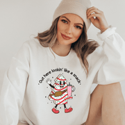 Our gender-neutral pullover features an adorable Christmas tree cake holding a sturdy Stanley water bottle, and flaunting a belt bag with a sassy message that reads "Out here lookin' like a snack".