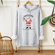 Our gender-neutral hoodie features a cute Santa Claus holding a Stanley water bottle, and wearing a belt bag that reads "Santa Baby, leave a Stanley under the tree for me" - because who doesn't love a good pun?