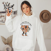 This hoodie features a cute little pumpkin pie holding a sleek Stanley water bottle while rocking a belt bag that reads “Out Here Lookin' Like A Snack." 