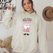 This gender neutral hoodie features a cute Santa holding a Stanley water bottle and sporting a trendy belt bag with the hashtag #SLEIGH. But wait, there's more! This hoodie is not just soft and comfortable, it's also magically warm - perfect for those cold winter nights. 