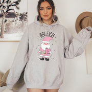This gender neutral hoodie features a cute Santa holding a Stanley water bottle and sporting a trendy belt bag with the hashtag #SLEIGH. But wait, there's more! This hoodie is not just soft and comfortable, it's also magically warm - perfect for those cold winter nights. 